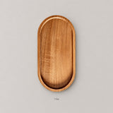 One small oval solid wood tray; no serving accessories included.