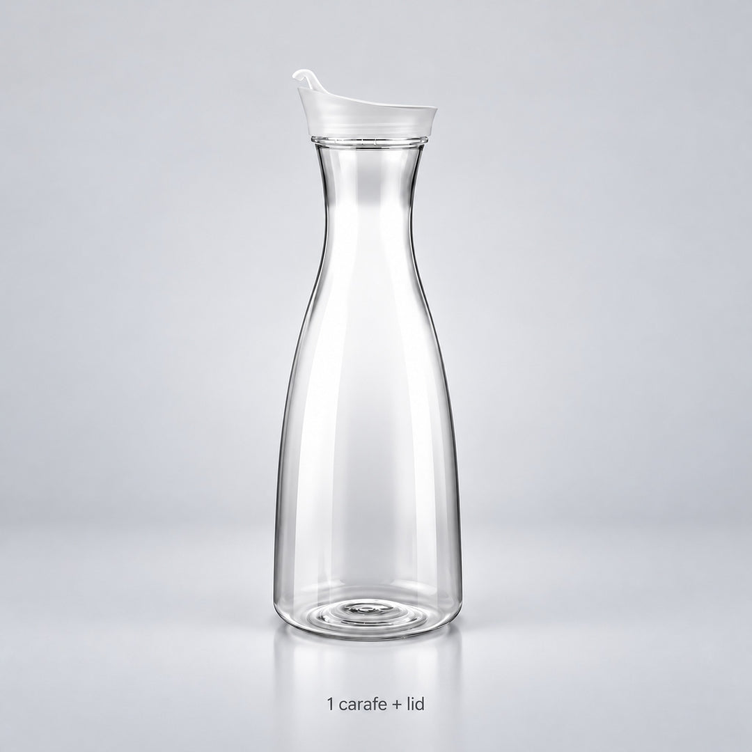 One empty clear plastic carafe with its fitted lid.