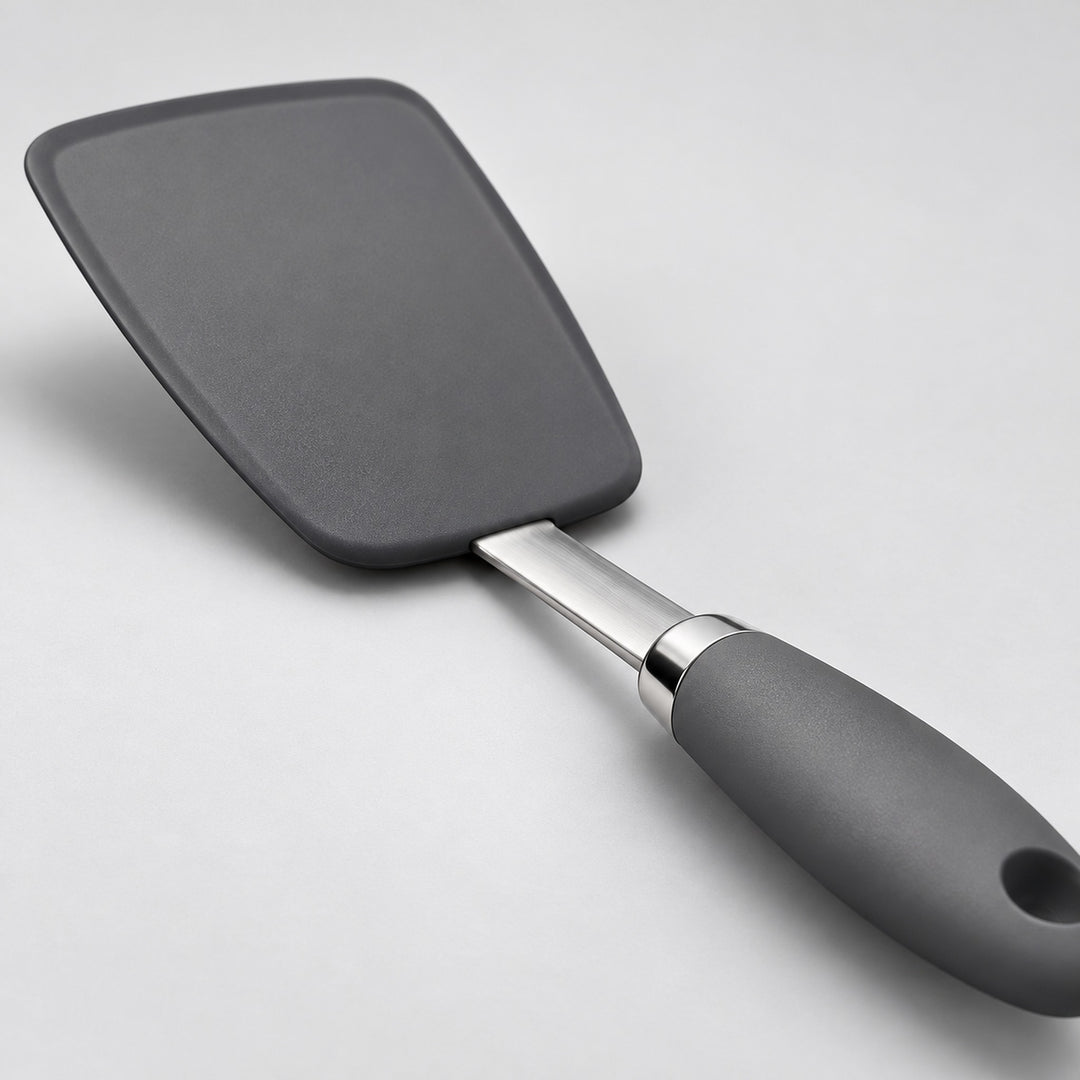 Close view of the silicone head, flat steel shaft, and metal collar.
