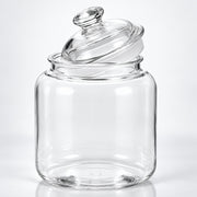 Clear glass jar with a matching glass lid, photographed on a clean white studio background.