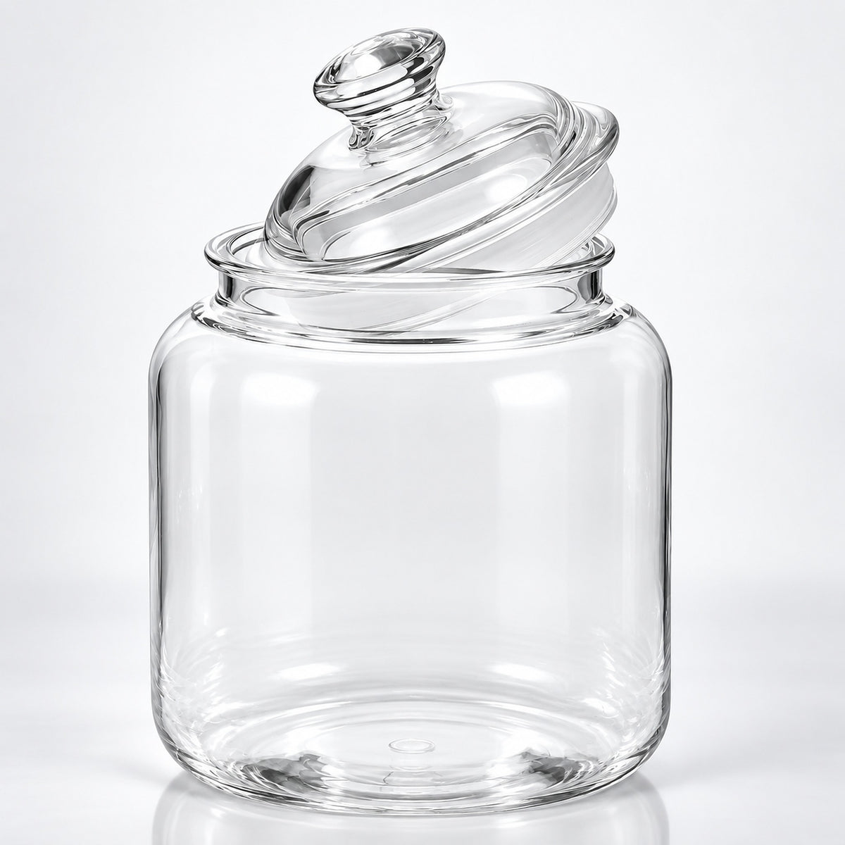 Clear glass jar with a matching glass lid, photographed on a clean white studio background.