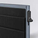 Close-up of the metal frame, textured front pocket and side lever.