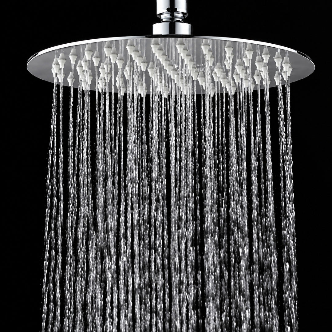A round chrome rain shower head with water cascading down against a solid black background.