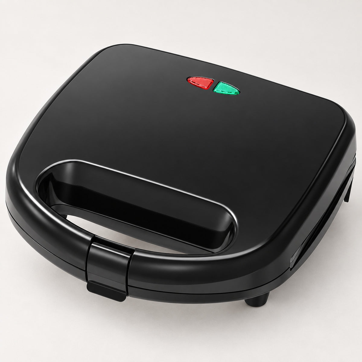 A black electric sandwich maker or mini toaster with a carrying handle, featuring red and green power buttons on top, shown on a light gray background.