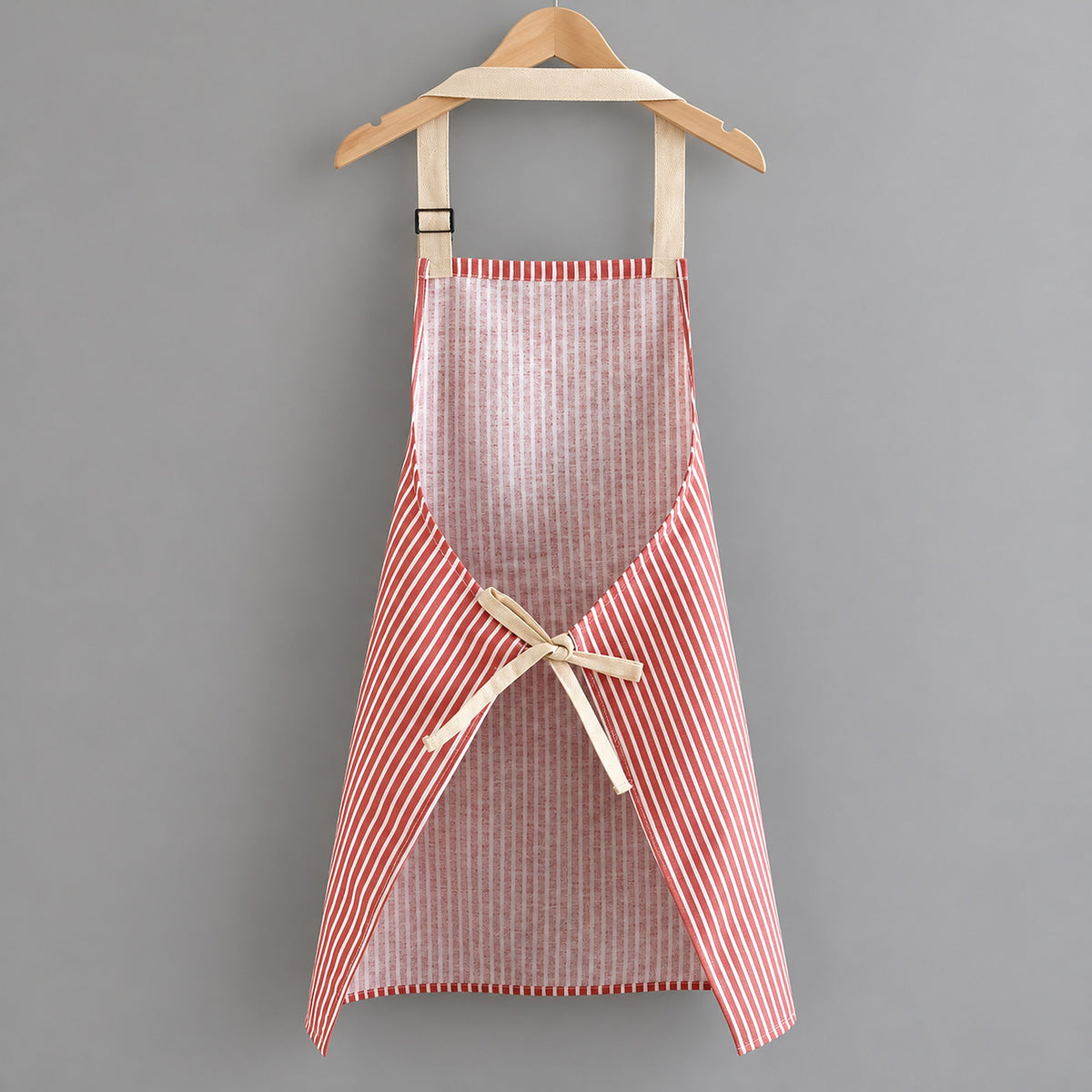 Back of the red striped apron showing the beige waist ties.