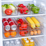 Clear refrigerator organizer bins arranging produce, cans, eggs, and bottles in fridge shelves