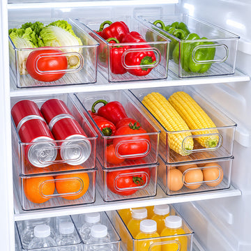 Clear refrigerator organizer bins arranging produce, cans, eggs, and bottles in fridge shelves