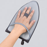 Mesh hand pocket and finger-retention strap on the steaming pad.