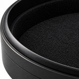 Macro of the round case aluminum rim and soft black lining.