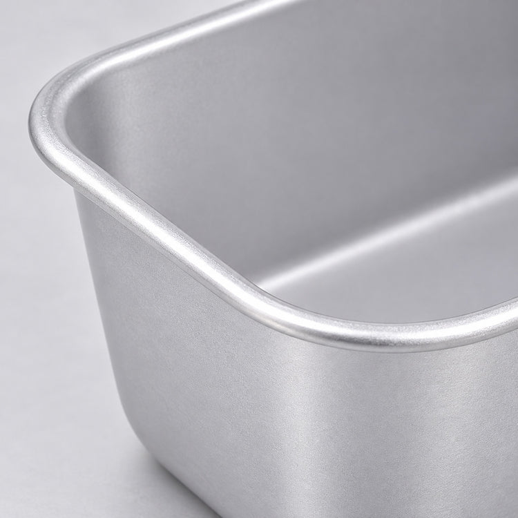 Close-up of the satin aluminum finish and rolled rim of the loaf pan.