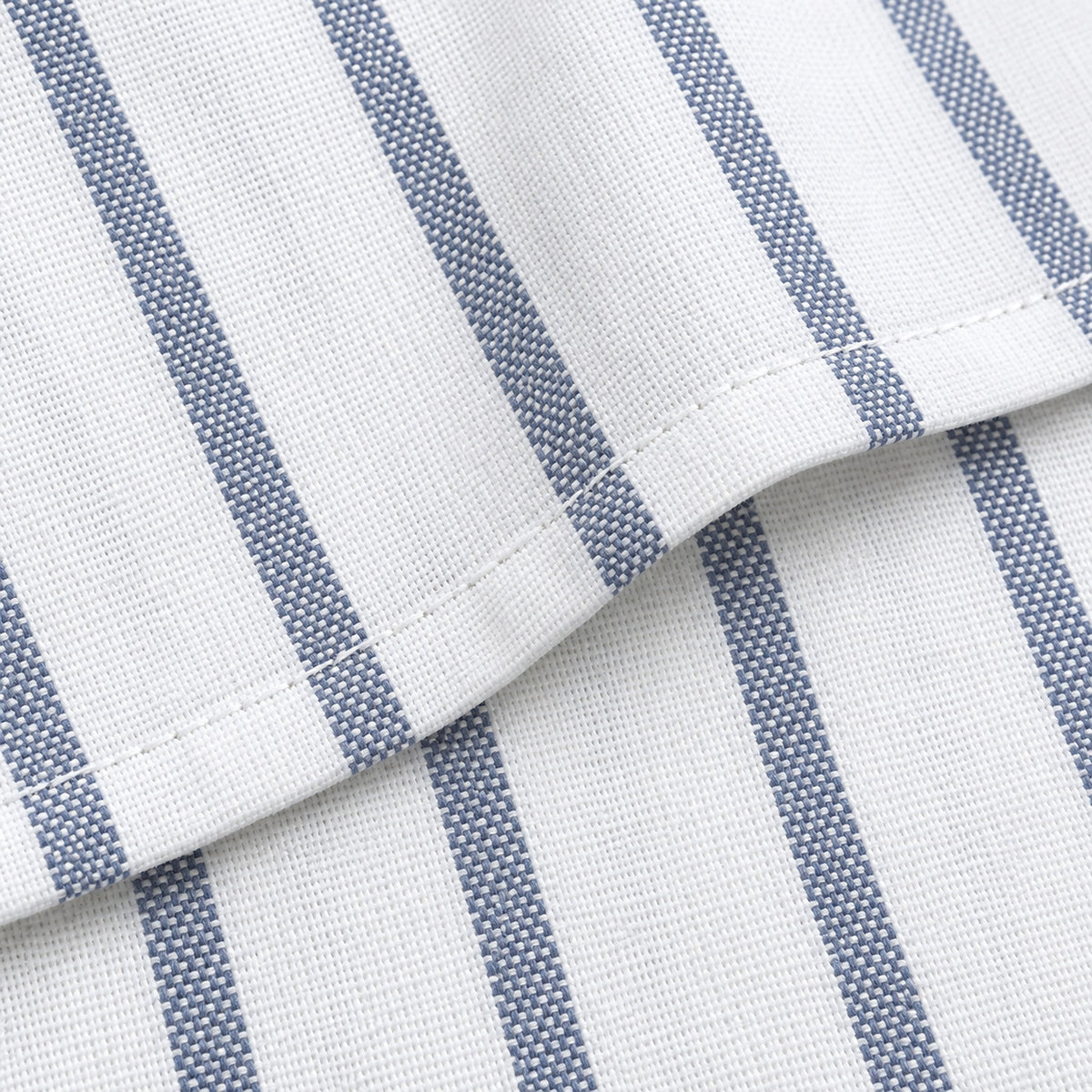 Macro of flat cotton weave, fine blue stripe and stitched hem.