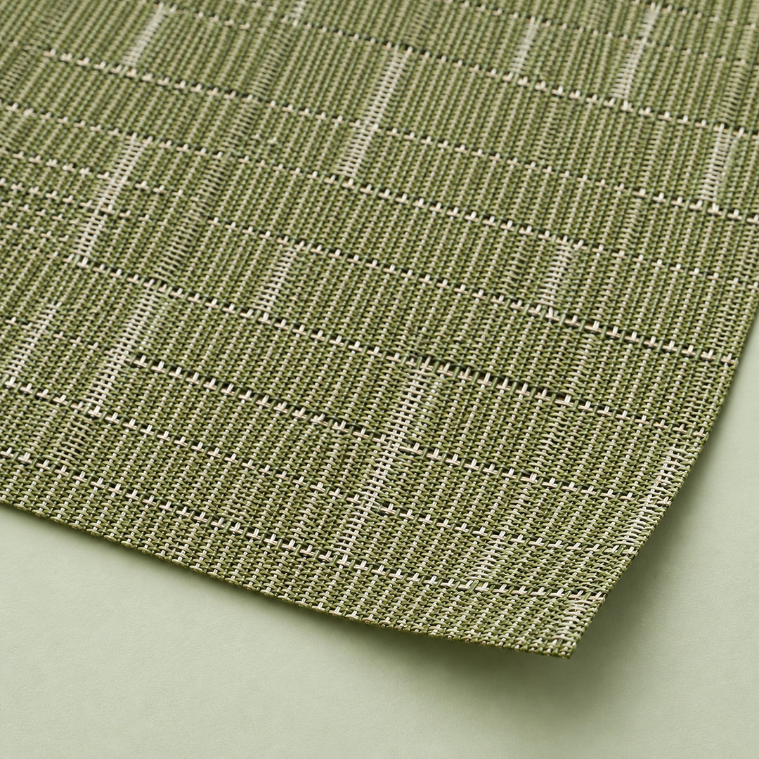 Close-up of olive-green vinyl weave and smooth trimmed corner.