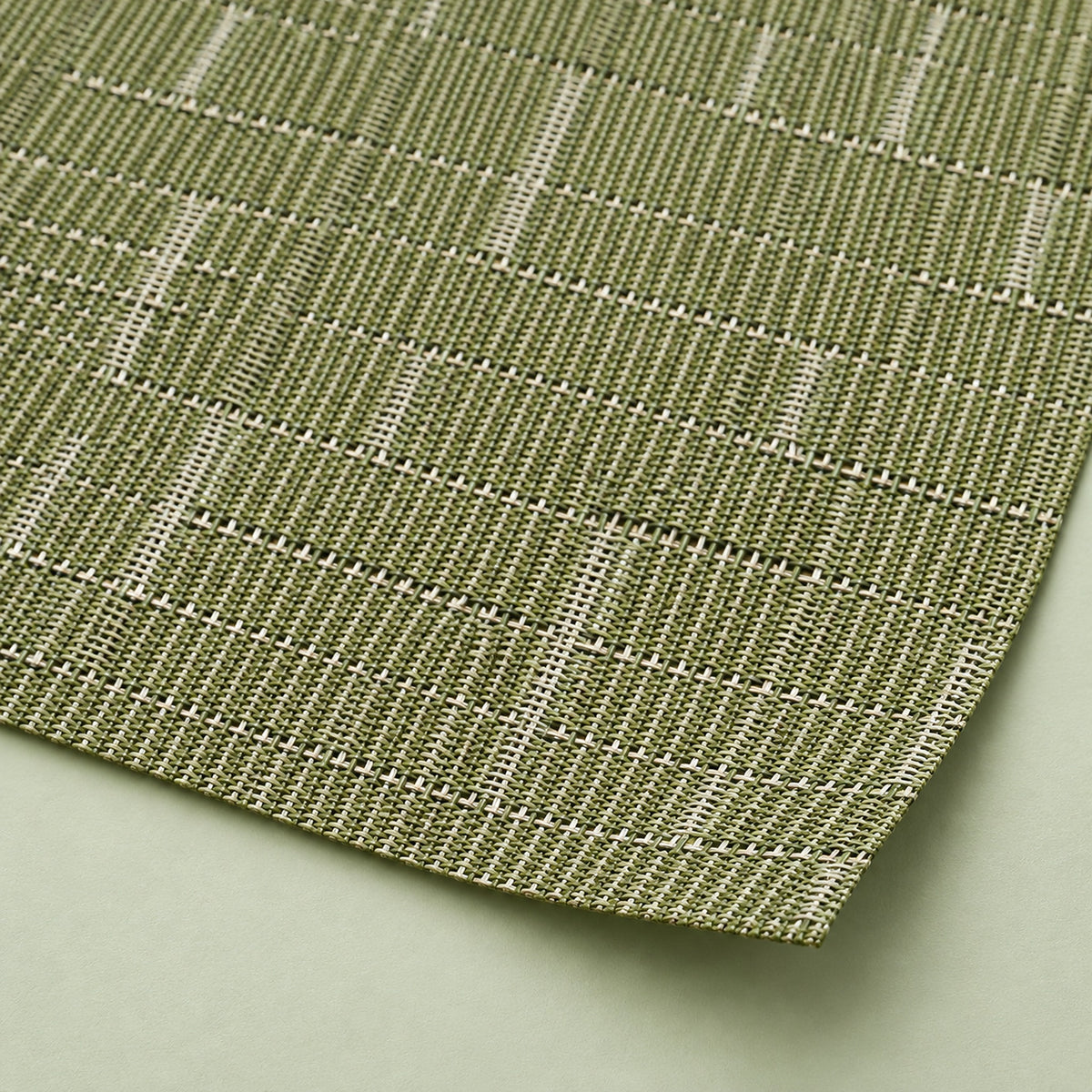 Close-up of olive-green vinyl weave and smooth trimmed corner.