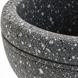 Close-up of the gray speckled finish and rounded mortar rim.