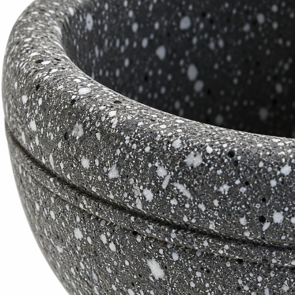 Close-up of the gray speckled finish and rounded mortar rim.