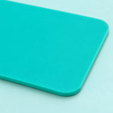 Smooth turquoise silicone coaster rounded corner and thin edge.