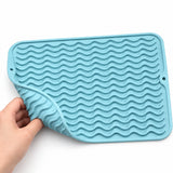 Flexible blue silicone mat corner with raised wavy ridges.