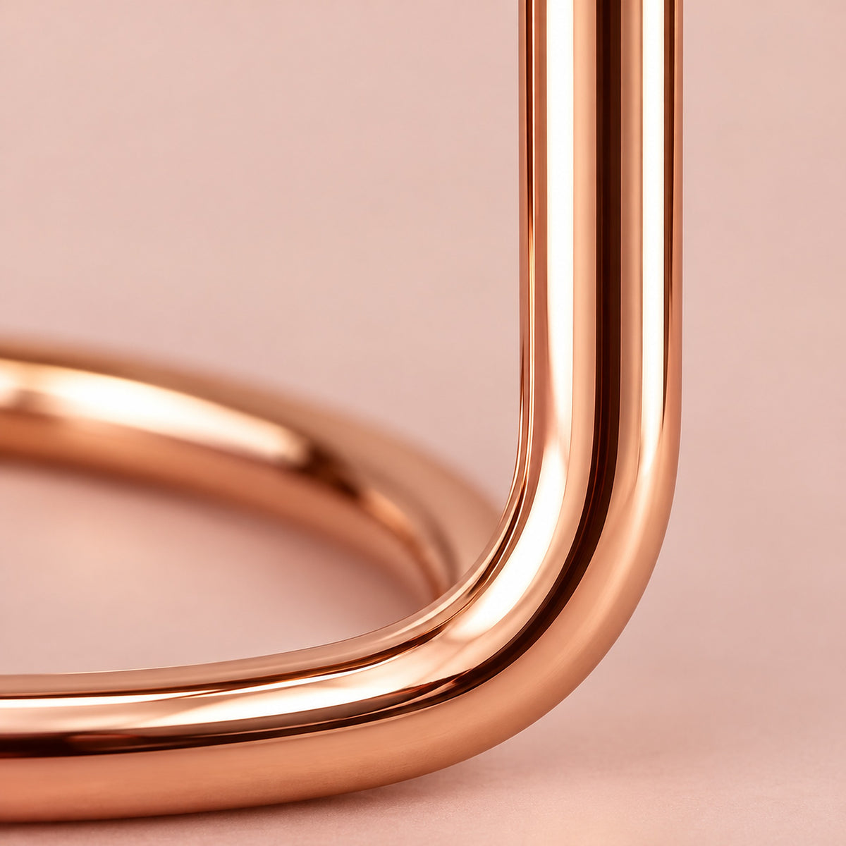 Close-up of the smooth rose-gold steel tube.
