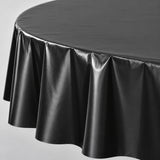 Close-up of black disposable PVC tablecloth sheen and soft folds.