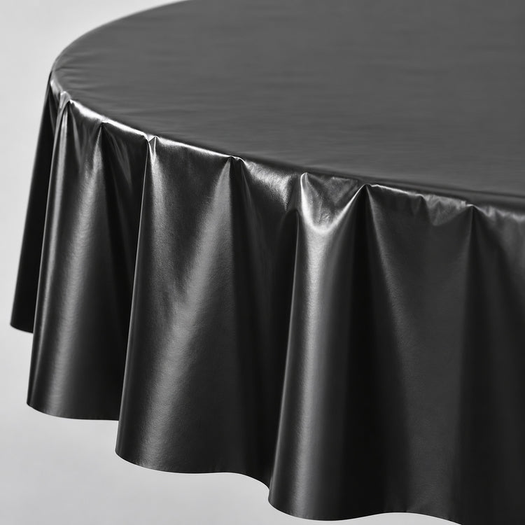 Close-up of black disposable PVC tablecloth sheen and soft folds.