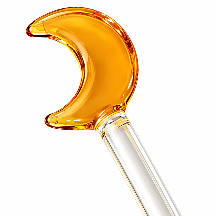 Close-up of amber crescent glass topper and clear stirring rod.