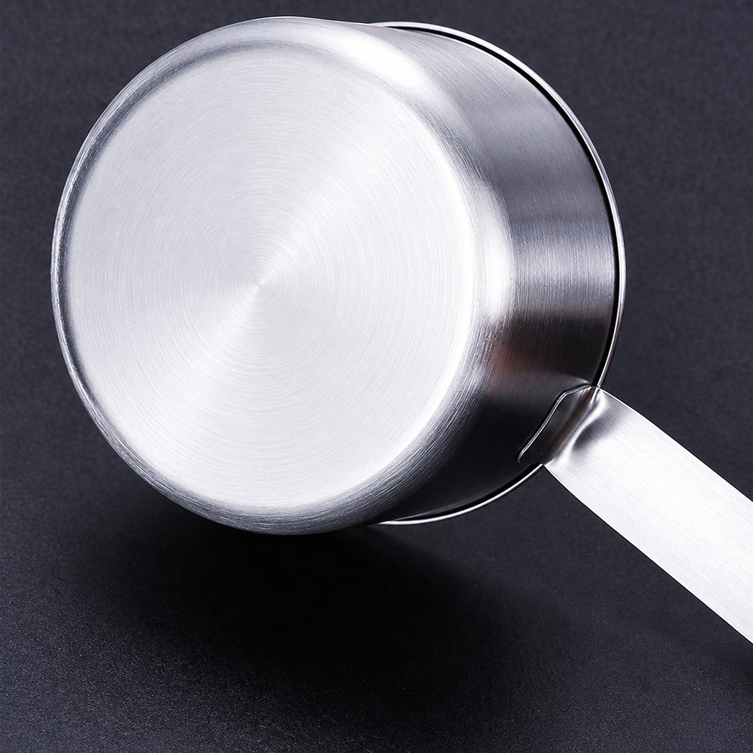Close-up of the measuring cup brushed stainless steel base and handle attachment.