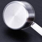 Close-up of the measuring cup brushed stainless steel base and handle attachment.