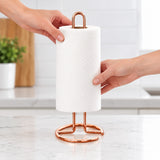 Loading a paper roll over the rose-gold upright loop.