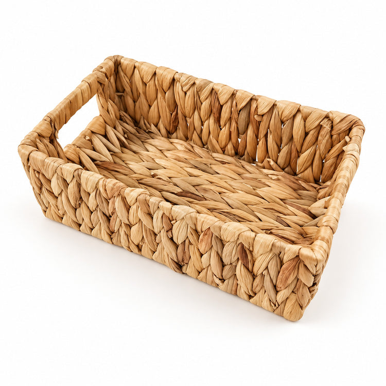 A rectangular woven tray made from natural seagrass or wicker, featuring integrated side handles and a slanted interior, shown on a plain white background.