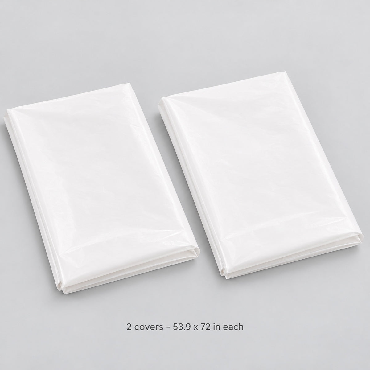 Two folded white covers, each 137 x 183 cm.