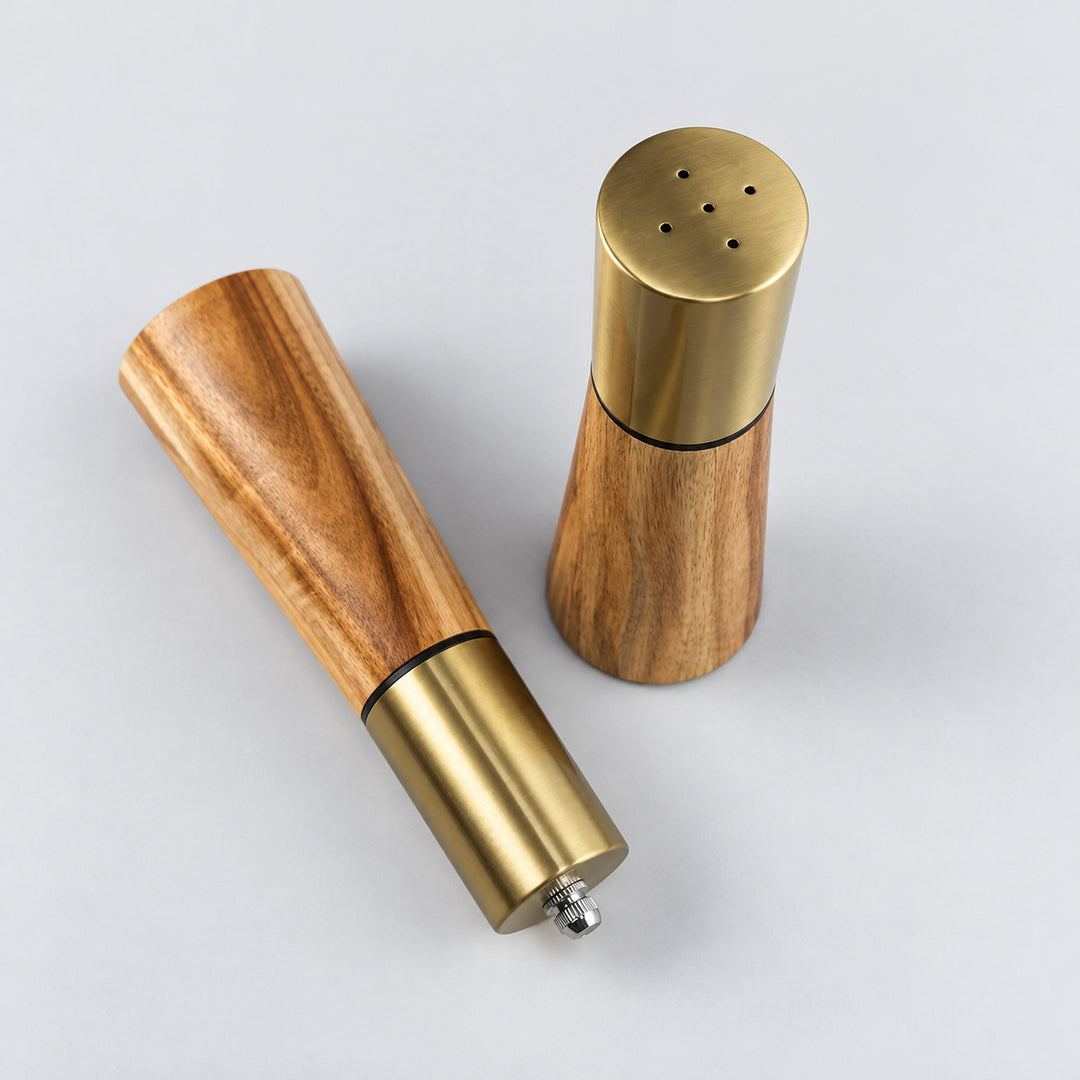Salt shaker dispensing holes beside the pepper grinder top adjustment nut.
