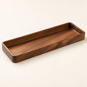 A rectangular wooden tray with rounded corners and a smooth, polished finish, shown on a plain off-white background.