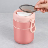 Pink jar's translucent lid disk lifted to reveal utensil storage.