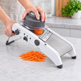 Mandoline preparing carrot strips with the food holder.