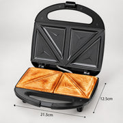 Black electric sandwich maker shown open with toasted bread inside, on a light gray background, with dimension labels indicating 21.5 cm width and 12.