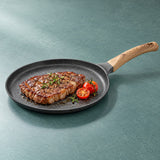 Shallow nonstick pan used to cook and serve steak.