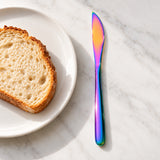 Rainbow dinner knife beside a breakfast plate; props not included.