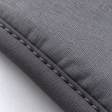 Gray padded fabric and stitched edge of the garment-steaming pad.