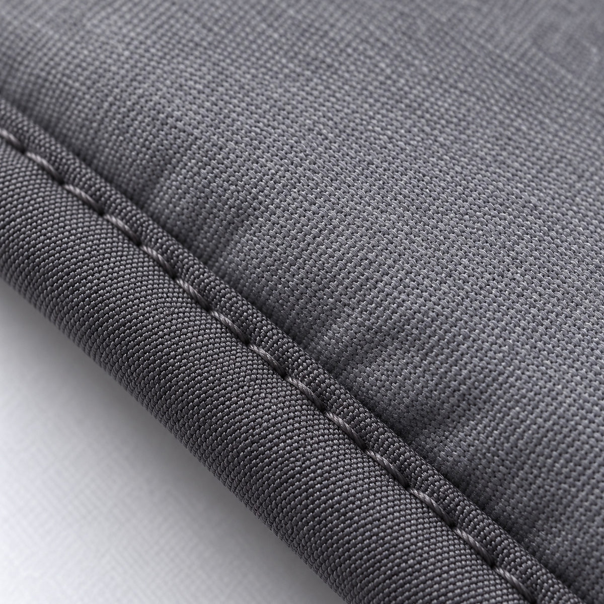 Gray padded fabric and stitched edge of the garment-steaming pad.
