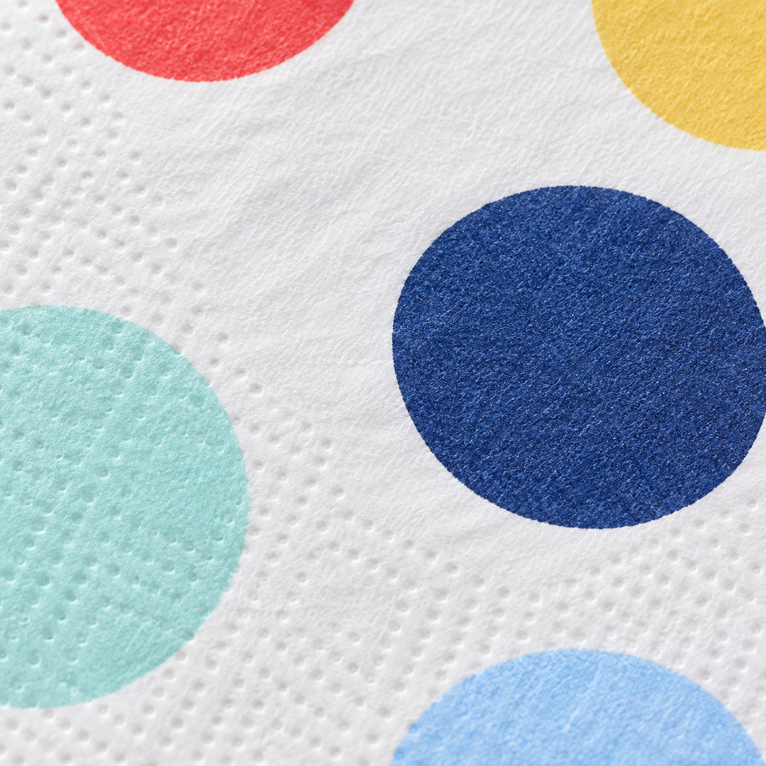 Embossed paper texture and navy dot print detail.