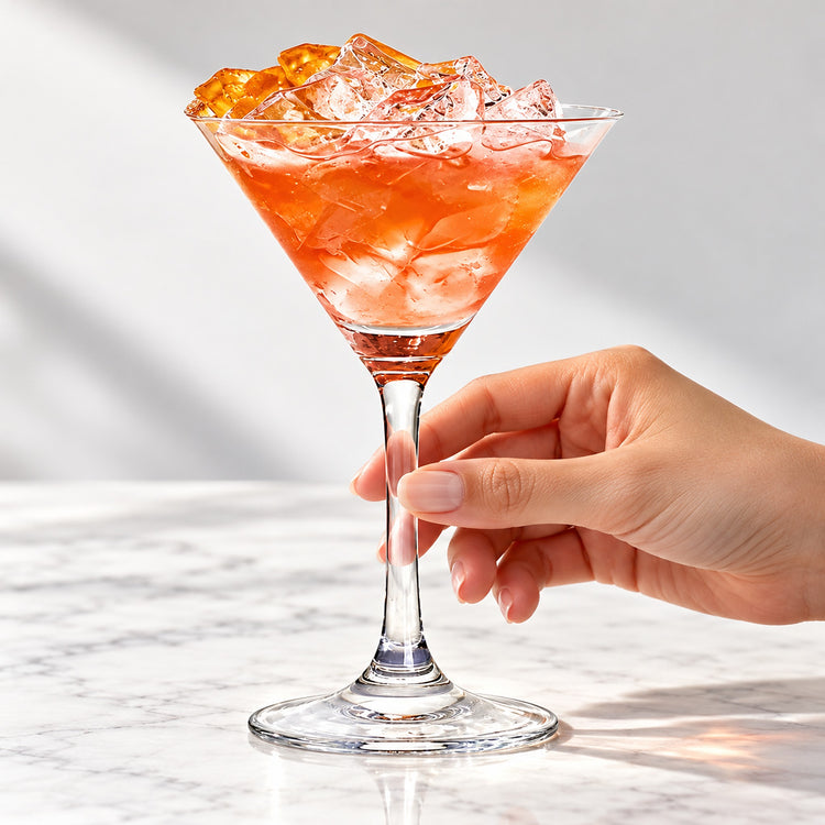 Straight-stem martini glass serving a citrus cocktail.