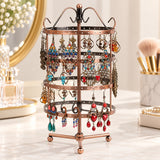 Bronze four-tier tripod stand displaying paired earrings.