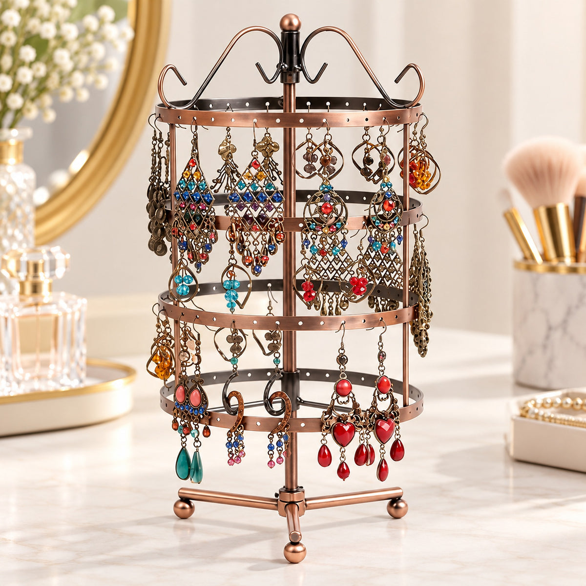 Bronze four-tier tripod stand displaying paired earrings.