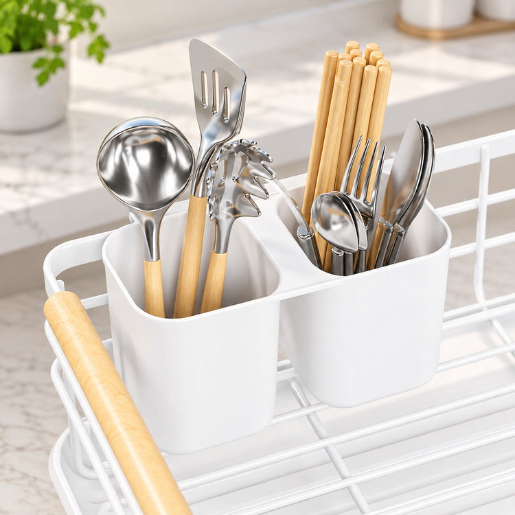 A white dual-compartment utensil holder filled with metal kitchen tools and chopsticks, placed on a white wire rack in a bright kitchen setting.