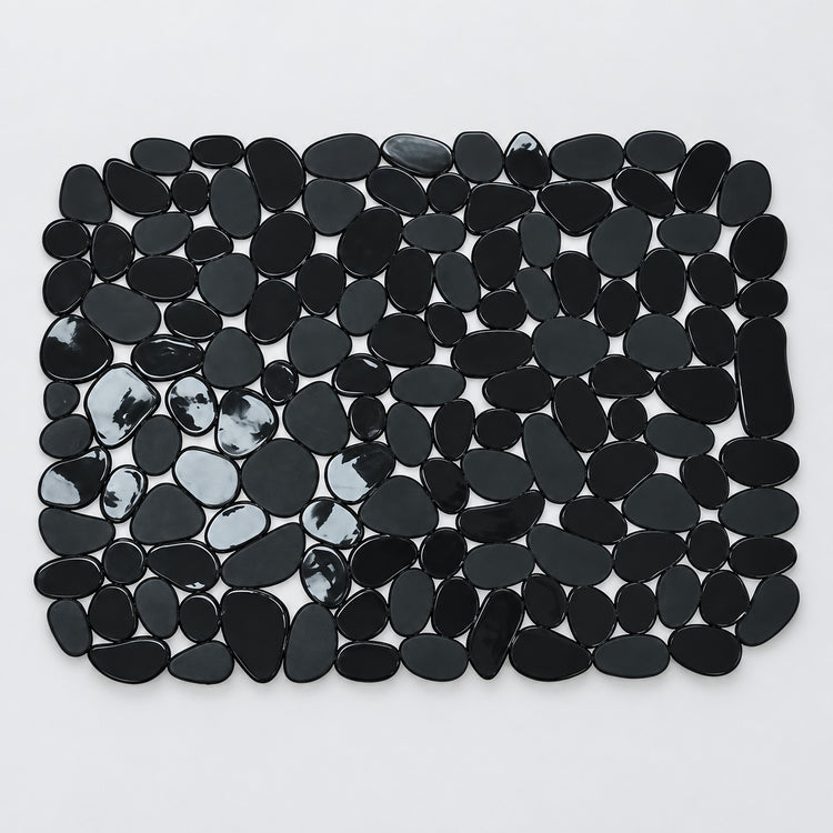 A rectangular arrangement of glossy black pebble-shaped tiles or stones on a plain white background.