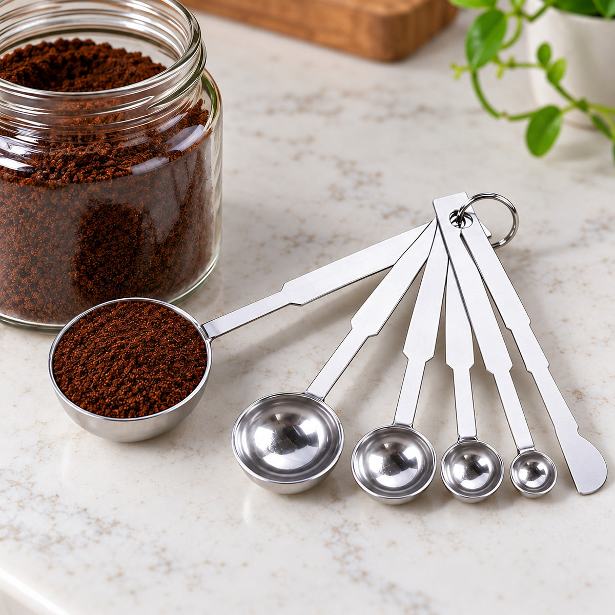 Measuring spoon used to portion coffee; five-spoon set includes a flat leveler.