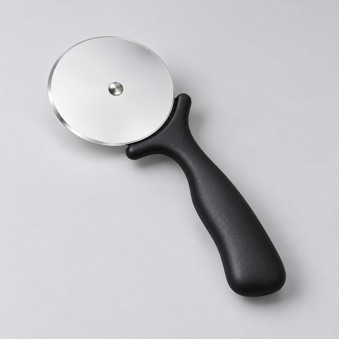 Angled view of the black pizza cutter and thin steel wheel.