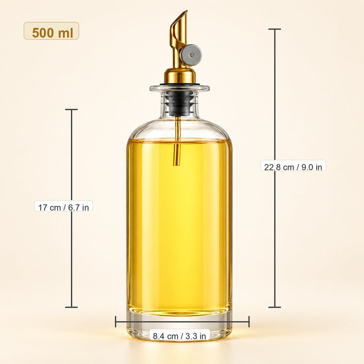 A 500 ml clear glass oil dispenser bottle filled with golden yellow oil, featuring a gold-toned metal pour spout and black collar. The image includes dimension lines and text showing the bottle's height (22.