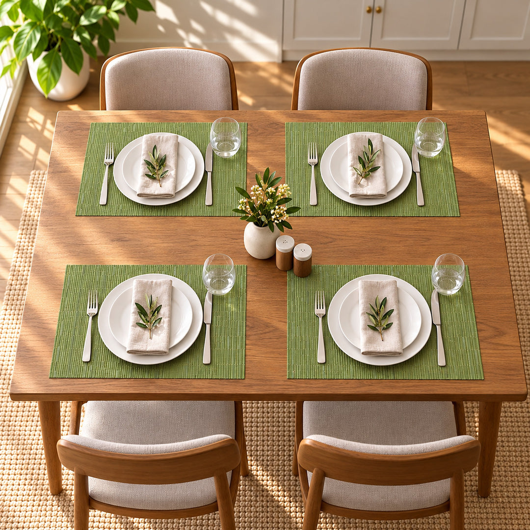 Four matching green placemats arranged for a family meal.