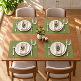 Four matching green placemats arranged for a family meal.